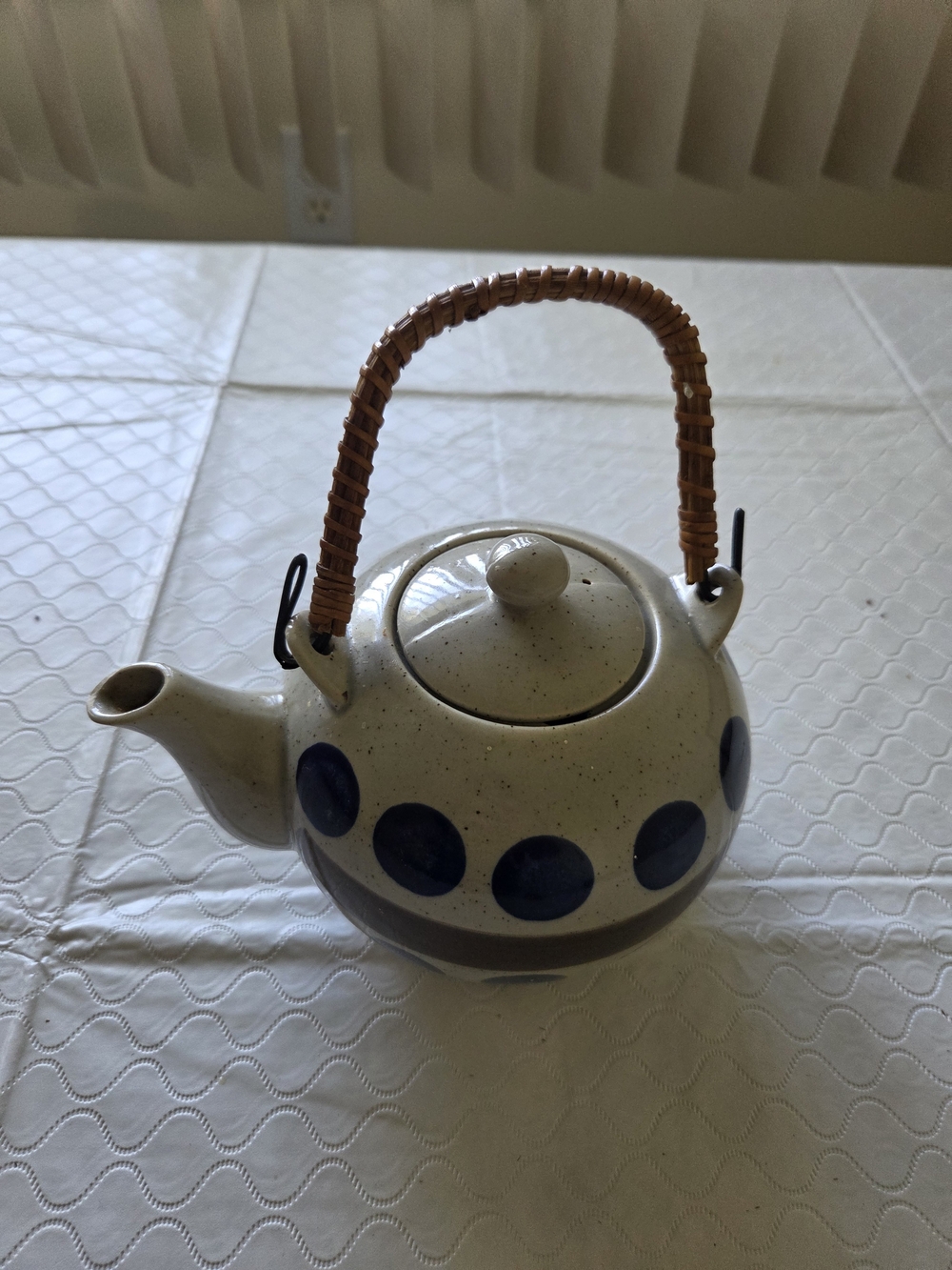 Wicker-Handled Ceramic Teapot with Blue Dot Design